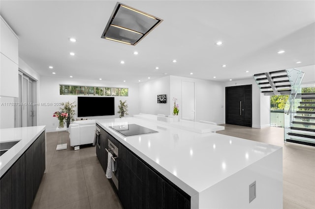 641 NW 7th St Rd, Miami, FL 33136 - kitchen with modern cabinets, open floor plan, black electric cooktop, dark cabinetry, and recessed lighting