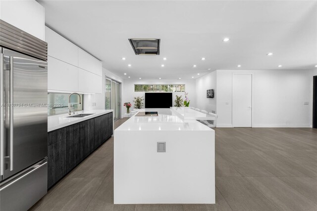 641 NW 7th St Rd, Miami, FL 33136 - kitchen featuring built in fridge, open floor plan, white cabinetry, a sink, and modern cabinets