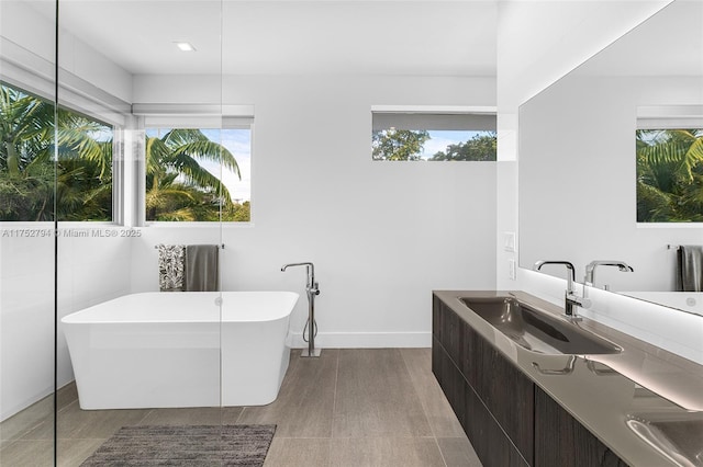 641 NW 7th St Rd, Miami, FL 33136 - full bathroom with a soaking tub, baseboards, and vanity