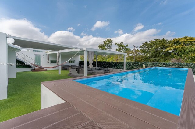 641 NW 7th St Rd, Miami, FL 33136 - view of swimming pool featuring an outdoor hangout area and a lawn