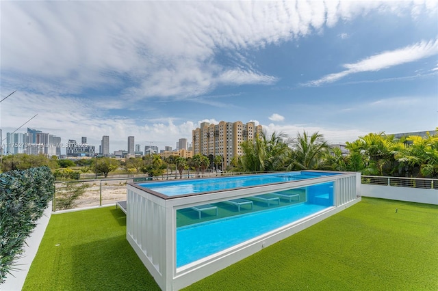 641 NW 7th St Rd, Miami, FL 33136 - view of pool featuring a view of city, a yard, and a fenced in pool
