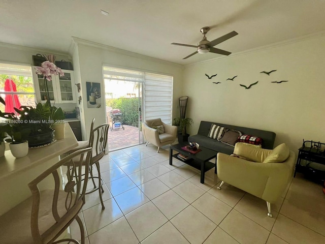 living room featuring light tile patterned floors, a ceiling fan, and crown molding