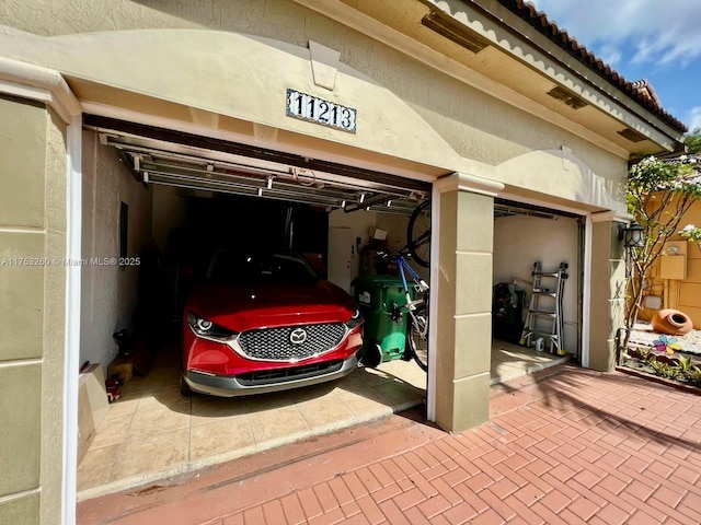 garage featuring decorative driveway