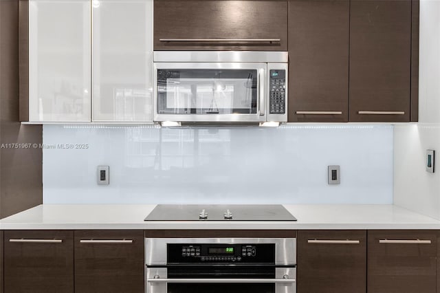 kitchen with modern cabinets, appliances with stainless steel finishes, and dark brown cabinets