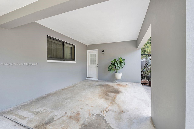 property entrance with a patio area and stucco siding