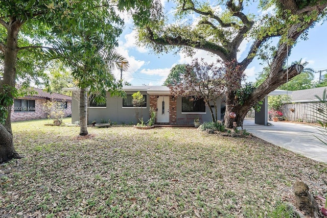 ranch-style house with driveway and stucco siding