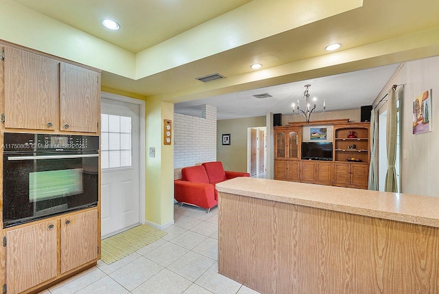 kitchen featuring light countertops, open floor plan, oven, and light tile patterned floors