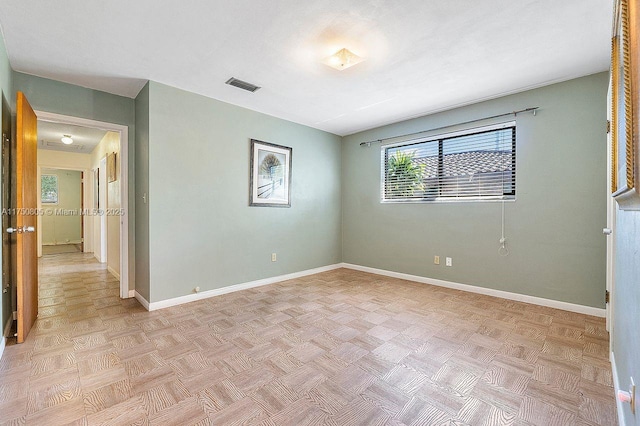 empty room featuring visible vents and baseboards