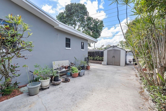 view of patio / terrace with a storage shed and an outbuilding