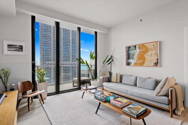 living room with expansive windows and wood finished floors