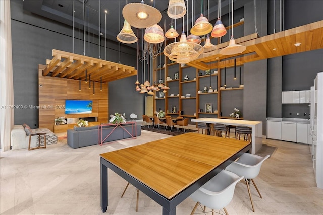 dining room with a towering ceiling