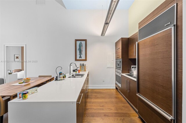 475 Brickell Ave Unit 2809, Miami, FL 33131 - kitchen with built in appliances, a sink, modern cabinets, and light countertops