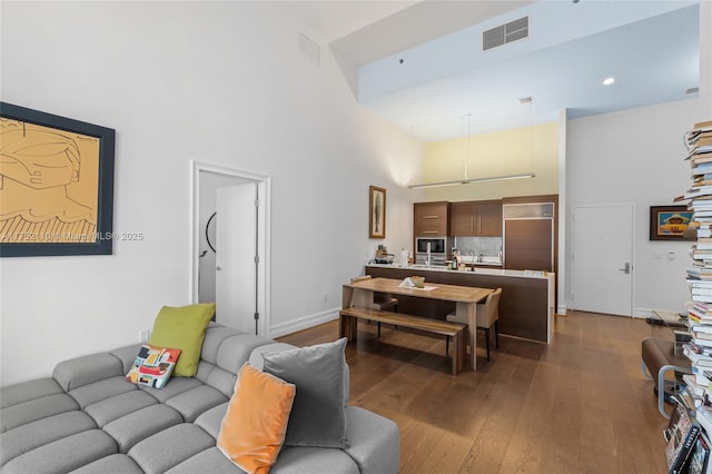 475 Brickell Ave Unit 2809, Miami, FL 33131 - living room featuring a towering ceiling, dark wood-style floors, baseboards, and recessed lighting