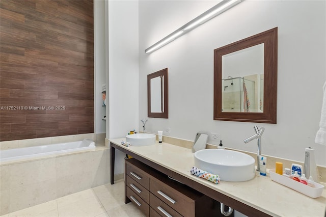 full bath featuring tiled tub, a sink, a tile shower, and tile patterned floors