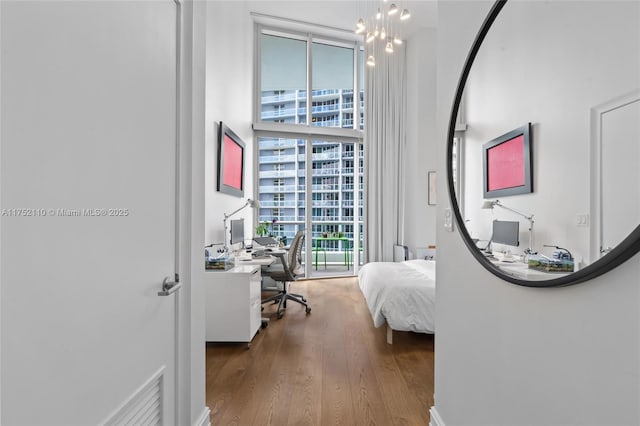 475 Brickell Ave Unit 2809, Miami, FL 33131 - bedroom featuring a desk, wood finished floors, and a towering ceiling