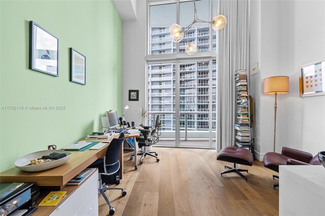 475 Brickell Ave Unit 2809, Miami, FL 33131 - home office with wood finished floors and a towering ceiling