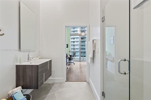 475 Brickell Ave Unit 2809, Miami, FL 33131 - full bath with tile patterned floors, vanity, baseboards, and a stall shower