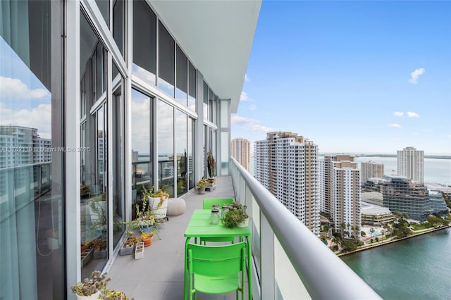 balcony featuring a water view and a view of city