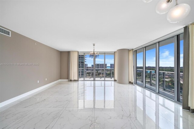 300 Sunny Isles Blvd Unit 4-1208, Sunny Isles Beach, FL 33160 - spare room featuring a chandelier, a wall of windows, and light marble finish flooring