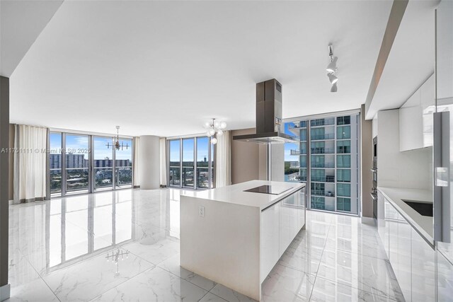 300 Sunny Isles Blvd Unit 4-1208, Sunny Isles Beach, FL 33160 - kitchen featuring modern cabinets, a chandelier, black electric stovetop, white cabinets, and island range hood