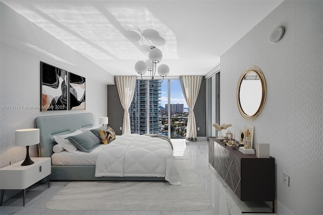 bedroom featuring marble finish floor, a view of city, floor to ceiling windows, and a notable chandelier