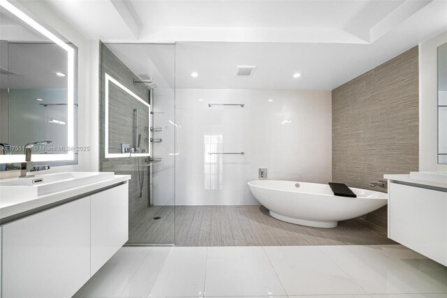 300 Sunny Isles Blvd Unit 4-1208, Sunny Isles Beach, FL 33160 - full bathroom with tile walls, vanity, walk in shower, a freestanding bath, and tile patterned flooring