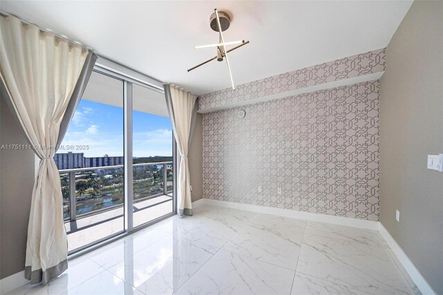 300 Sunny Isles Blvd Unit 4-1208, Sunny Isles Beach, FL 33160 - empty room with a wall of windows, marble finish flooring, wallpapered walls, a city view, and a water view
