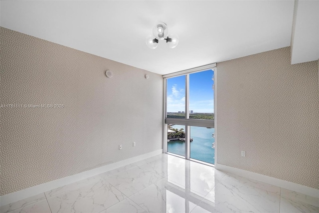 300 Sunny Isles Blvd Unit 4-1208, Sunny Isles Beach, FL 33160 - empty room with floor to ceiling windows, light marble finish flooring, and a water view
