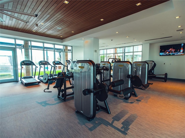 gym with carpet floors, recessed lighting, wooden ceiling, and floor to ceiling windows