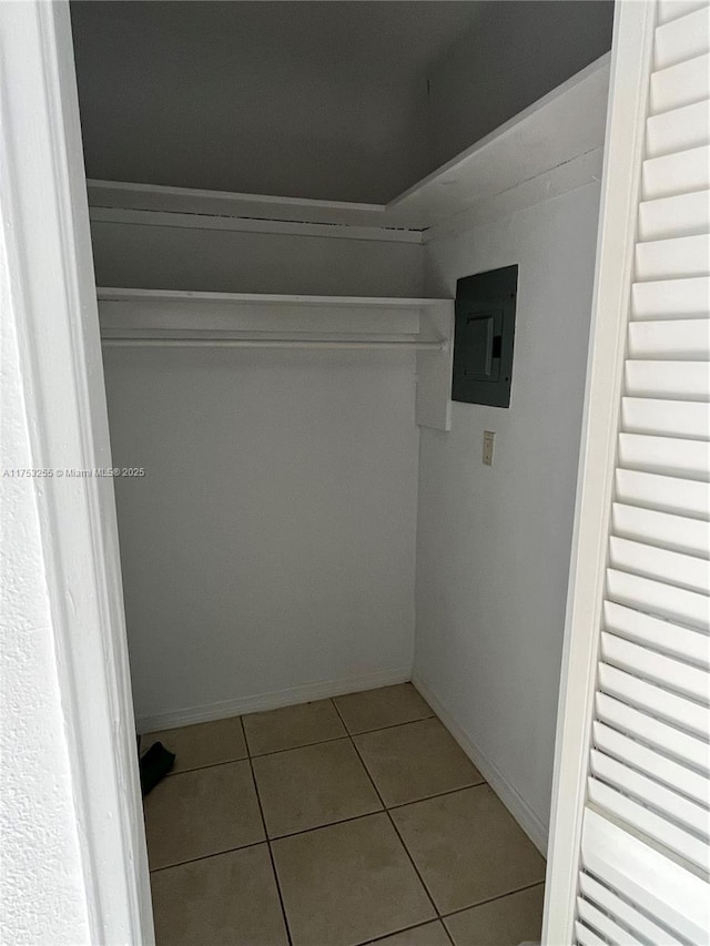 walk in closet featuring tile patterned flooring and electric panel