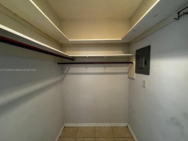 walk in closet featuring tile patterned flooring and electric panel