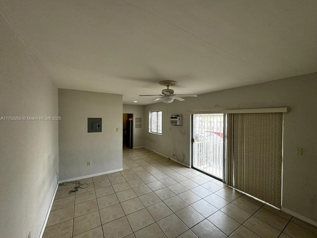 unfurnished room featuring light tile patterned floors, electric panel, ceiling fan, a wall mounted air conditioner, and baseboards