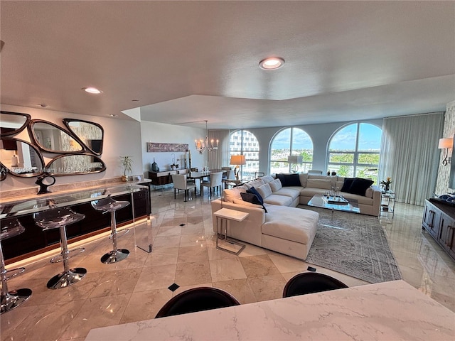 living room featuring a chandelier and recessed lighting