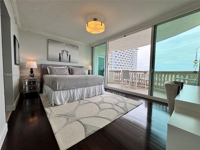 bedroom featuring access to exterior, floor to ceiling windows, and hardwood / wood-style flooring