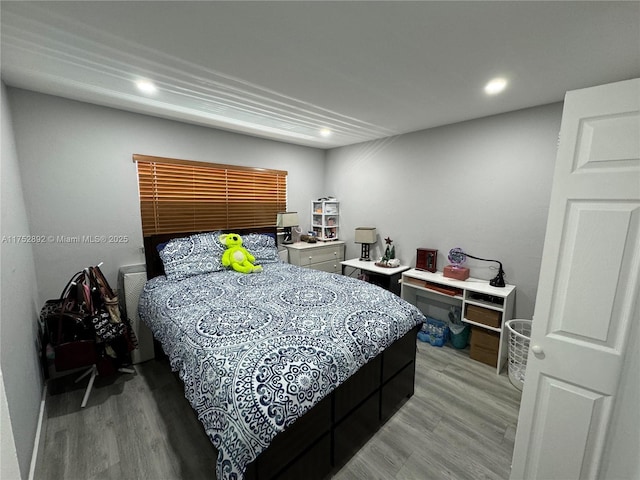 bedroom with light wood-type flooring and recessed lighting