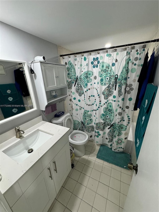 bathroom featuring tile patterned flooring, shower / tub combo, toilet, and vanity