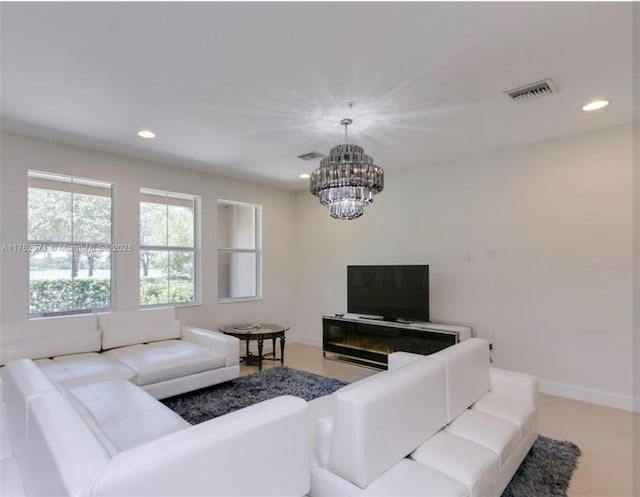 living area with baseboards, visible vents, a notable chandelier, and recessed lighting