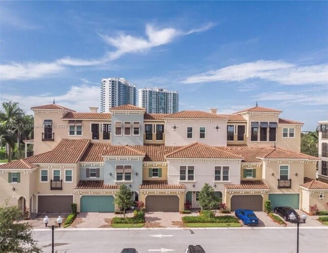 2910 NW 124th Way Unit 2910, Sunrise, FL 33323 - view of front of property featuring a garage, a tile roof, and stucco siding