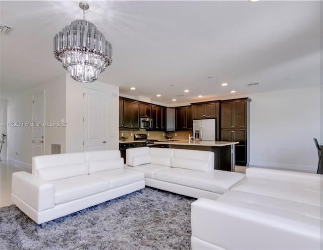 2910 NW 124th Way Unit 2910, Sunrise, FL 33323 - living room with recessed lighting, a chandelier, and baseboards
