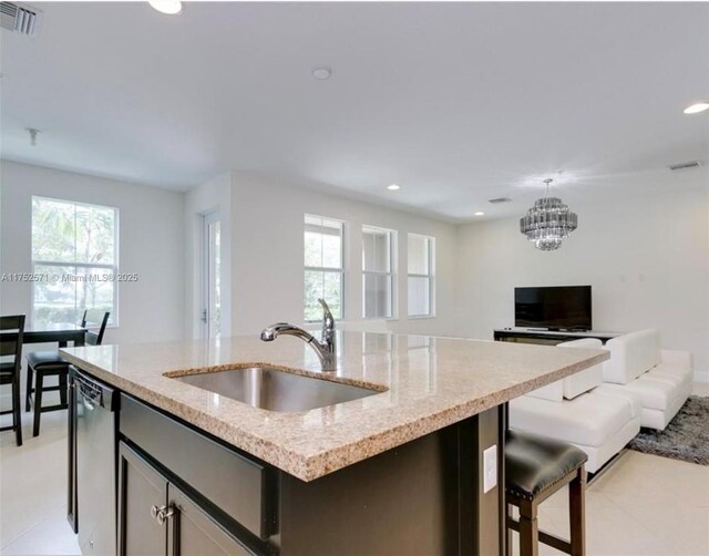 2910 NW 124th Way Unit 2910, Sunrise, FL 33323 - kitchen featuring a sink, dishwasher, open floor plan, an island with sink, and light stone counters