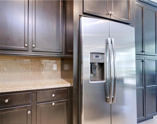 2910 NW 124th Way Unit 2910, Sunrise, FL 33323 - kitchen featuring stainless steel fridge with ice dispenser, dark brown cabinetry, tasteful backsplash, and light stone counters