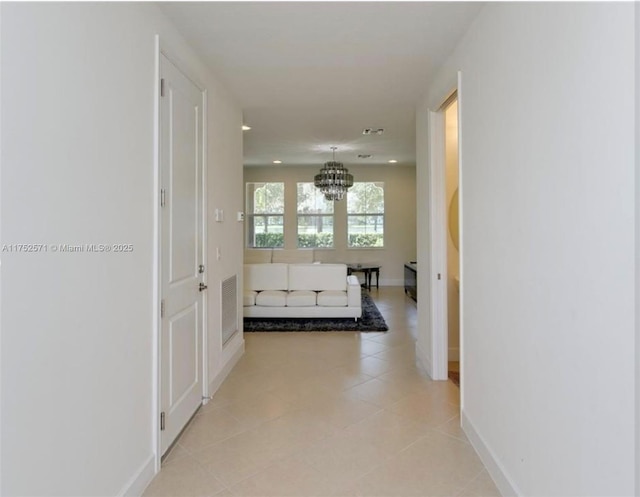 2910 NW 124th Way Unit 2910, Sunrise, FL 33323 - hallway featuring a chandelier, baseboards, light tile patterned floors, and recessed lighting