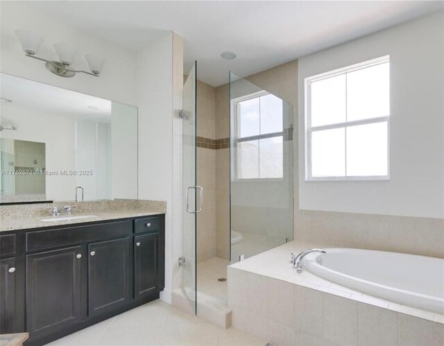 2910 NW 124th Way Unit 2910, Sunrise, FL 33323 - full bathroom featuring a garden tub, a shower stall, vanity, and tile patterned flooring