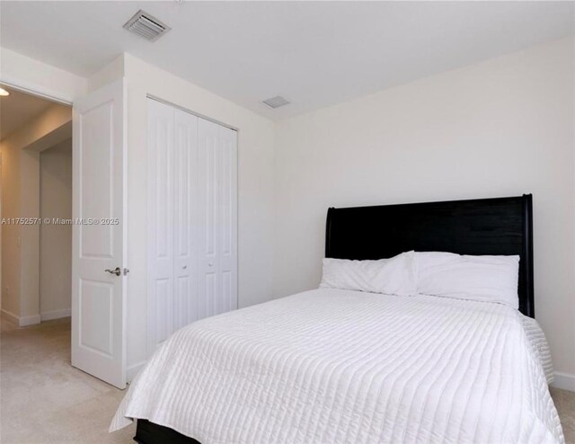 2910 NW 124th Way Unit 2910, Sunrise, FL 33323 - bedroom featuring light carpet, a closet, and baseboards