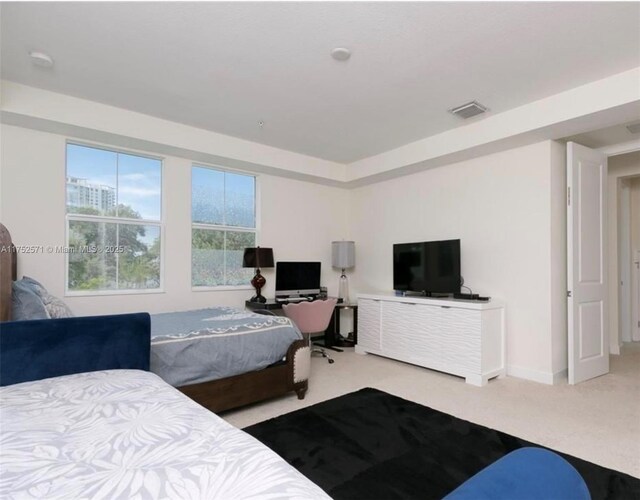 2910 NW 124th Way Unit 2910, Sunrise, FL 33323 - carpeted bedroom with a desk and baseboards