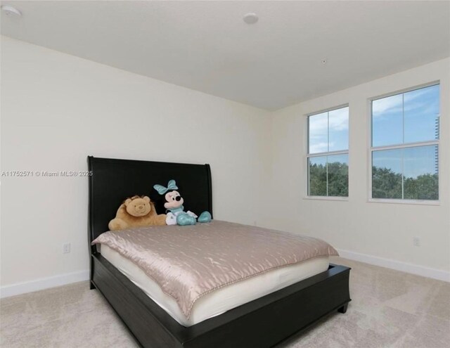 2910 NW 124th Way Unit 2910, Sunrise, FL 33323 - bedroom with baseboards and light carpet
