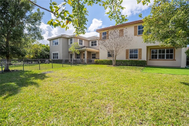 exterior space featuring a front yard, fence, and stucco siding