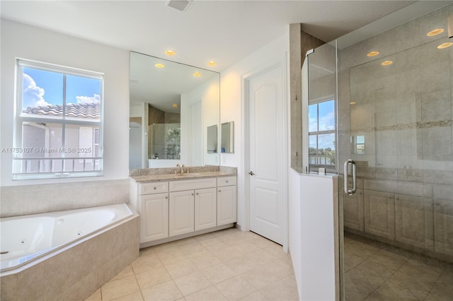 bathroom with a stall shower, a tub with jets, tile patterned flooring, vanity, and recessed lighting