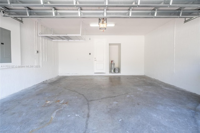 garage with a garage door opener and electric panel