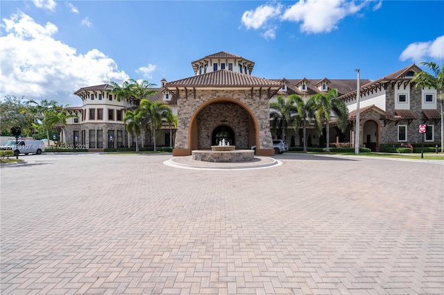 view of building exterior featuring curved driveway